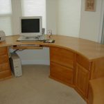 natural wooden u shaped desk design with closed file organizer and printer and computer set beneath large glass window with blind