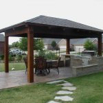 outdoor pavilion plans with outdoor kitchen idea with wooden pillar and black roof plus natural stone floor and pathways at beautiful garden backyard