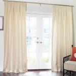 sheer linen inverted pleat drapes curtains on glass door combined with armchair with cushion