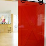 wooden sliding barn doors for closets in red combined with wooden laminate floor