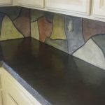 Creative and unique concrete backsplash for kitchen with gloss black countertops