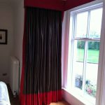 Elegant and modern black and red curtain for corner windows wood planks floor system glass window and trims