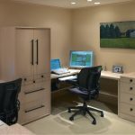 office design for two persons with white tone modular desk components with cupboard beneath cream wall with picture