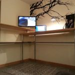 super large standing desk design with tall pole and wooden tops in different height with tree mural on the wall