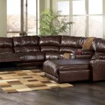 Brown leather reclining sectionals with single chaise a small area rug in light and deep brown color scheme