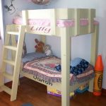 beautiful crib size bunk bed design with mini stairs and purple bedding and toy basket and hardwood floor and navy blue area rug