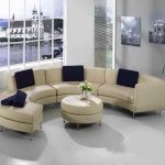 most comfortable sofas in white and curved shape plus blue cushion and round ottoman table with flower vase