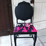 posh black painting fabric furniture idea with magenta accent and round carved backrest on white washed wooden floor aside farm door