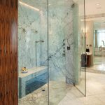 sleek frameless glass enclosed showers modern granite bathroom brown wooden bathroom closet