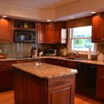 Dark Cabinet With Brown Color On iTs Kitchen Set