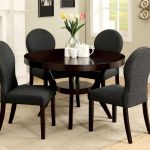 Dark brown coated wooden round table four microfiber upholstered chairs