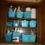 Wall bathroom cabine t with blue plastic storage boxes