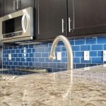 astonishing colored subway tile for kitchen backsplash decorated with wooden kitchen cabinets and modern space saving microwave plus marble countertop