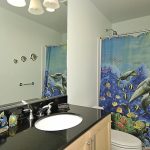 luxurious-sea-themed-bathroom-design-with-large-mirror-and-sea-themed-shower-curtains-for-kids-bathroom-with-white-wall-and-white-sink