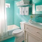 stunning turquoise blue bathroom with towel shelf and vanity and tub and curtain and toilet seat and fresh flooring