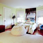 stylish-and-pretty-kids-bedroom-with-bright-blue-papasan-chair-and-pink-cushion-near-white-carpet-on-the-wooden-floor-also-brown-wooden-cabinet-and-dresser
