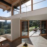 great sustainable home interior design with skylght and open plan and wooden furniture and siding and forest view