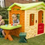 Outdoor playhouse from Tikes which is completed with built in table and a pair of X base small benches