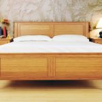 Solid wood platform bed frame  with headboard white bedding set a pair of solid wood bedside tables with drawers