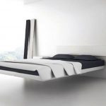 gorgeous white floating worth platform bed design with black bedding and open plan