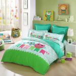 lovable green and blue owl bedding sheet with turquoise pillows and white end table and owl printed curtain idea and wall racks
