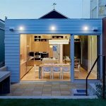 luxurious small house design with open plan adn extended living space and glass door and deck facade and wall lighting