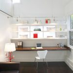 simple floating corner desk with wall mounted shelves together with track light fixture and white office chairs and dark wooden floor