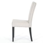 white upholstered dining chair covered with leather and embelished with nailheads for comfy dining area