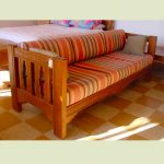 Low profile wood framed couch in strip motif
