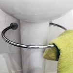 White Pedestal Sink With Towel Bar And Green Towel