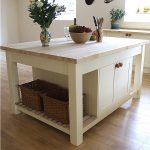 Lovely Wooden White Stand Alone Kitchen Islands With Baskets Flower Vase Plus Fruit On Top