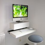 Simple and minimalist IKEA floating computer desk in white a round top chair without back feature