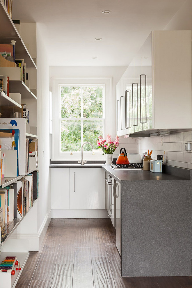 narrow kitchen with huge vertical book rack grey kitchen counter white cabinet idea dark hardwood floor idea