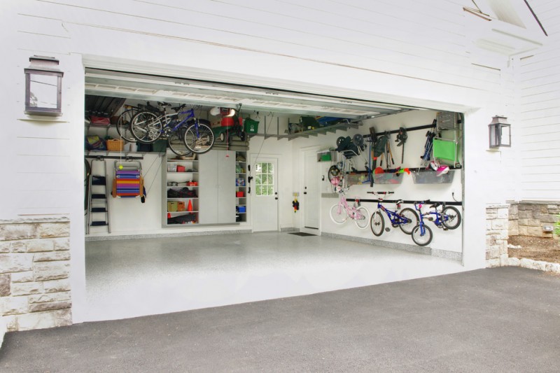 contemporary garage storage solution with wall mounted bins and hooks
