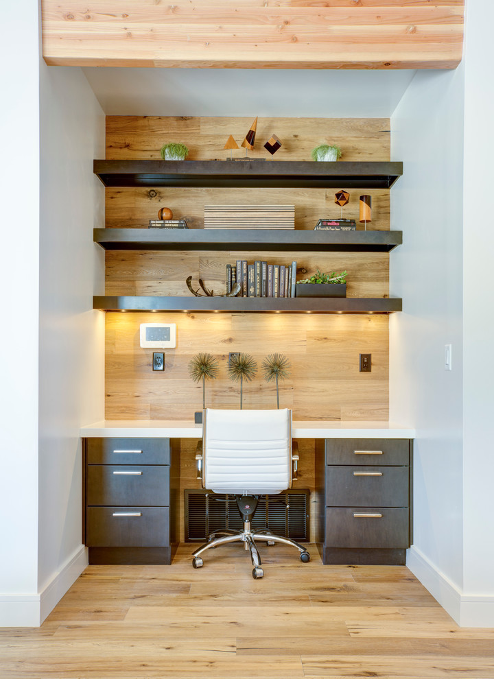 modern home office idea arranged recessed lamps black doff open shelves for books wood wall background white top working table movable white working chair light toned wood floors