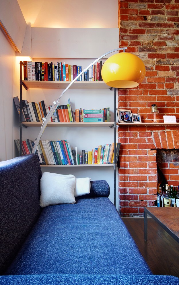 industrial home library with half way bricks walls and white painted concrete walls simple black iron book shelves