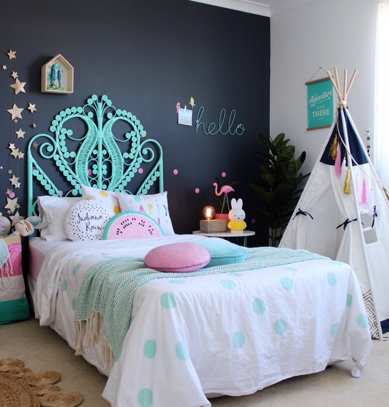 fancy kids' bedroom idea bed frame with hand crafted headboard in blue white bedding treatment with cute blue and pink accents dark wall background