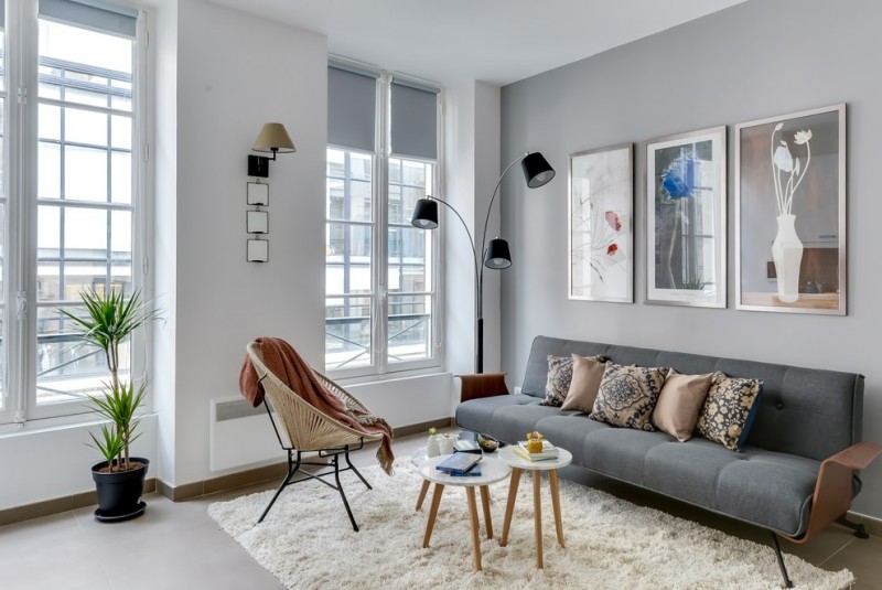 simple modern living room in grey grey mid century modern sofa modern floor lamps with black lampshades mid century modern chair and tables white shag rug