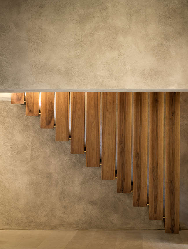 interior stairs in different angle wood plank railings concrete walls
