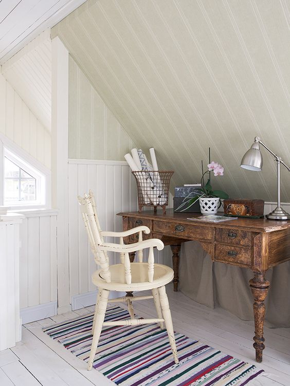 farmhouse home office in attic antique wood working desk vintage chair in white striped runner with fun colors