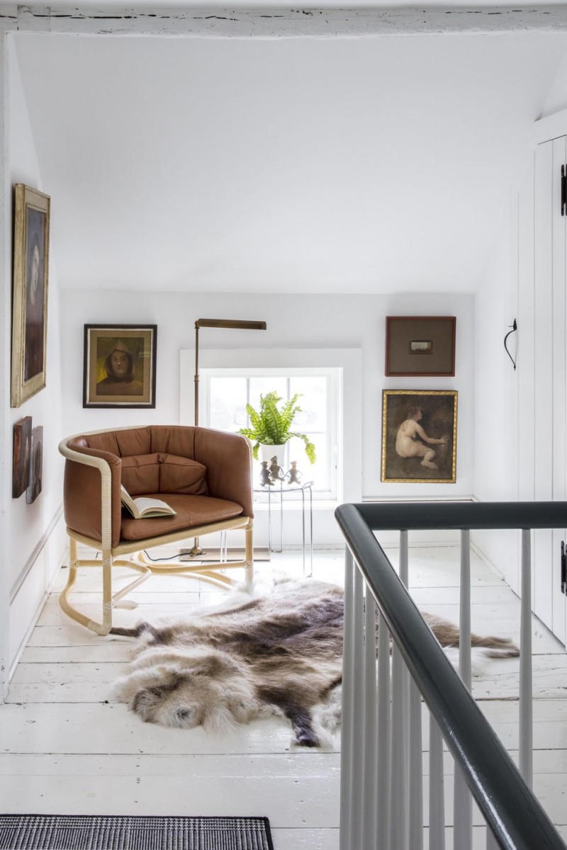 hallway reading corner idea modern arm chair with metal frame fur throw rug modern floor lamp white crisp walls and floors