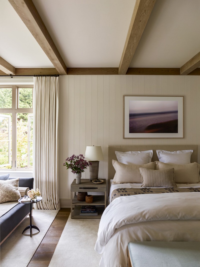 cream master bedroom with exposed wood beams cream and white bed treatment product blue velvet sofa