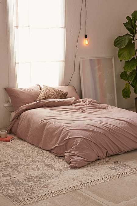 pale pink bedding treatment Boho rug with subtle patterns and tassels