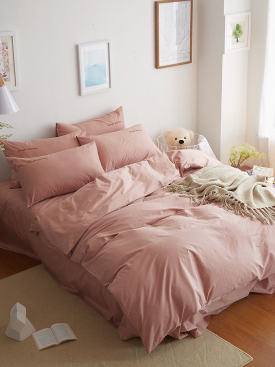 blush pink linens crisp white walls wood floors cream toned area rug