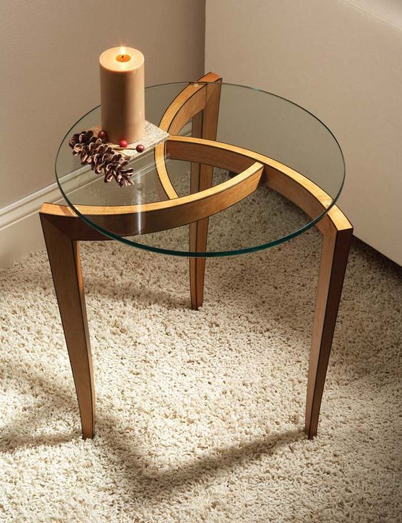 eyecatching side table with round glass top and unique wood frame