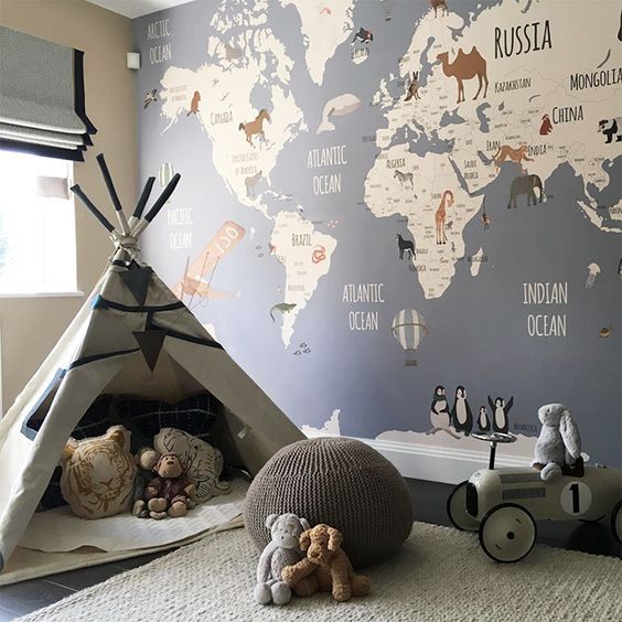 playroom in kids' room teepe some animal stuffs gray pouf flat woven rug in white world map wall decal