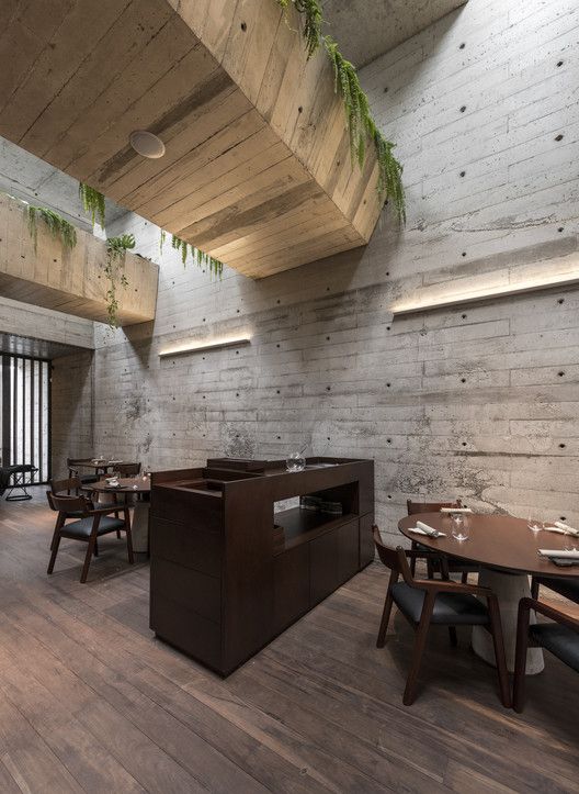 dining space with gardens on top wooden floors concrete walls dark wood dining furniture