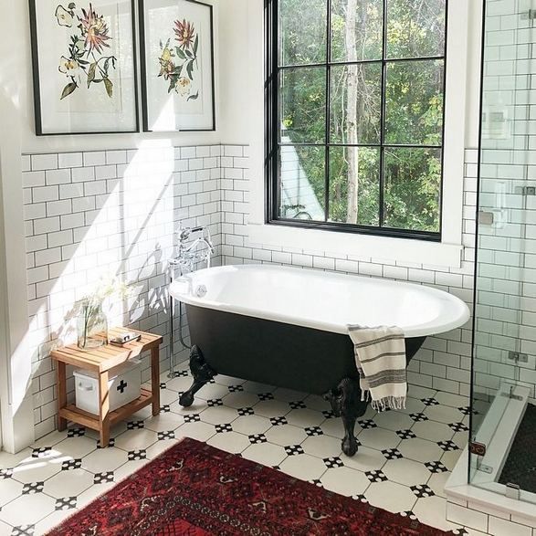 modern bathroom design with black clawfoot tub subway ceramic tile walls white tile floors with geometric patterns industrial style glass window